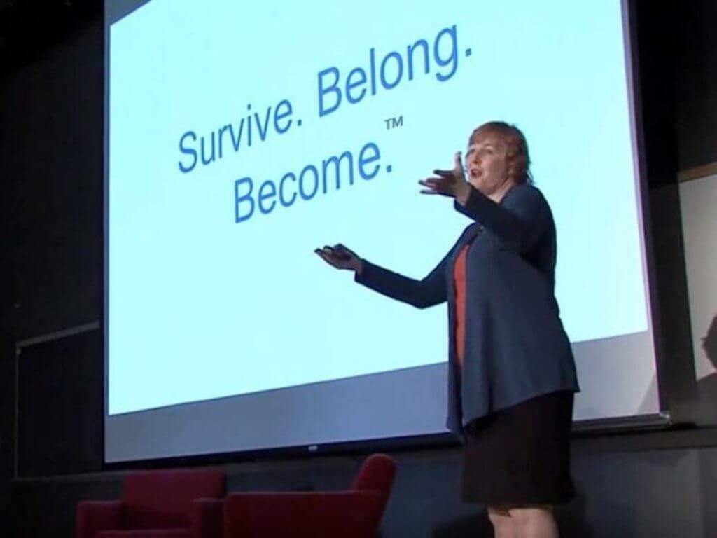 Britt Andreatta in front of projector presenting